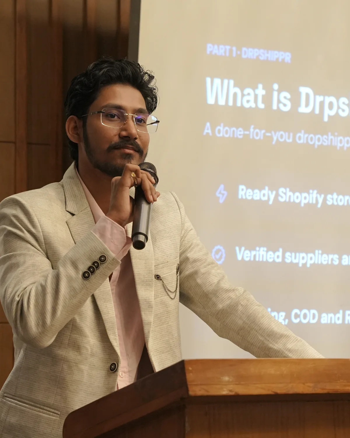 Aman Mudgal speaking on stage about Drpshippr