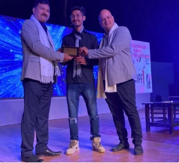 Aman receiving the CRPF event award on stage